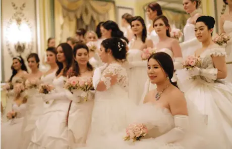  ??  ?? In this photo, Wendy Yu, lower right, joins with other debutantes for a group photo at the Internatio­nal Debutante Ball in New York. — AP photos