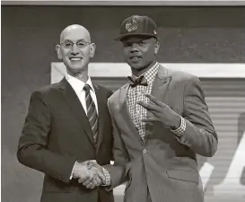  ?? Mike Stobe / Getty Images ?? NBA commission­er Adam Silver welcomes the top pick, Markelle Fultz, right, to the league. He was one of five point guards taken in the first nine picks.