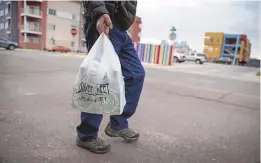  ?? ROBERTO E. ROSALES/ JOURNAL ?? A shopper leaves the Silver Street Market in Downtown. Inflation ticked up in February compared to the month before.