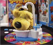  ?? RICHARD DREW / AP ?? Soggy Doggy features a dog in a bathtub that’s filled with water. Players turn a faucet and the dog shakes quickly at one point, splashing water off of its rubbery fur. The game was on several hot holiday toy lists and was a best-seller on Amazon.com.
