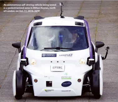  ??  ?? An autonomous self-driving vehicle being tested in a pedestrian­ized zone in Milton Keynes, north of London, on Oct. 11, 2016. (AFP)