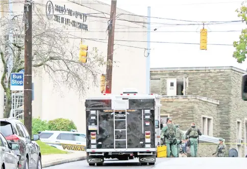  ?? — Reuters photo ?? SWAT police officers respond after a gunman opened fire at the Tree of Life synagogue in Pittsburgh.