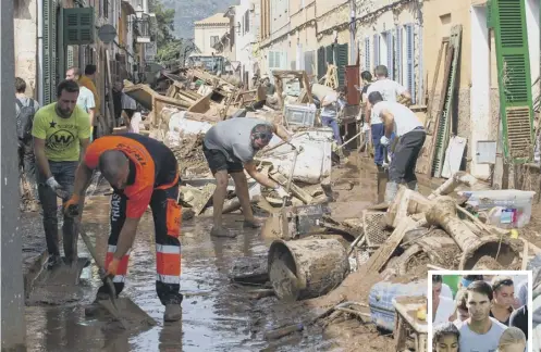  ?? PICTURE: JAIME REINA/AFP/GETTY IMAGES ?? 0 Locals clean up a street full of debris as tennis player Rafael Nadal, inset, who is from Majorca, is among those observing a minute of silence