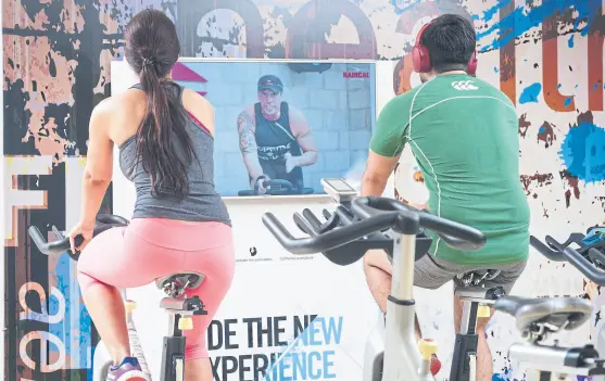  ??  ?? Rutina de spinning con entrenador virtual en el gimnasio On fit de microcentr­o