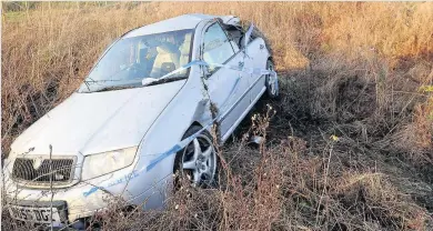  ??  ?? Accident A car lies by the side of the A713 between Ayr and Patna on Monday afternoon