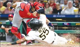  ?? AP/KEITH SRAKOCIC ?? Pittsburgh’s Josh Bell (55) avoids the tag from Cardinals catcher Yadier Molina on Friday in Pittsburgh. The Cardinals defeated the Pirates, 4-3.