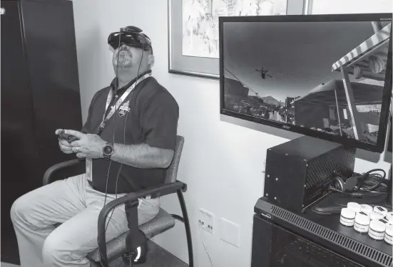  ?? Courtesy of UCF Restores ?? A patient participat­es in virtual realty exposure therapy at UCF RESTORES to help alleviate PTSD symptoms. The facility has treated nearly 250 first responders since 2016.