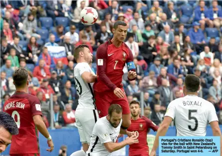  ??  ?? Portugal’s Cristiano Ronaldo (top) vies for the ball with New Zealand’s Tommy Smith in Saint Petersburg on Saturday. Portugal won 4-0.