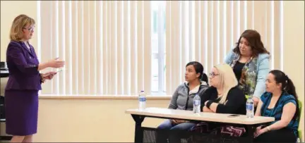  ?? ERIC BONZAR — THE MORNING JOURNAL ?? Lorain County Community College President Marcia Ballinger, left, shares informatio­n pertaining to the college’s English for Speakers of Other Languages classes offered at El entro de Servicios Sociales Inc. with three women who came to Lorain from...