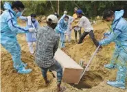  ?? AP PHOTO/ISHANT CHAUHAN ?? Relatives bury the body of a COVID-19 victim at a graveyard in New Delhi, India, on Tuesday. India’s official count of coronaviru­s cases surpassed 20 million Tuesday, nearly doubling in the past three months, while deaths officially have passed 220,000.