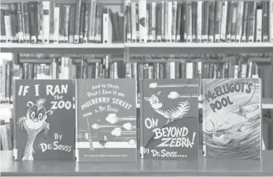  ?? CHRISTOPHE­R DOLAN/AP ?? Four of six titles by Dr. Seuss that the author’s estate decided earlier this year would no longer be published.