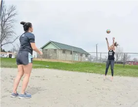  ??  ?? Chloe Cota, right, hits a volleyball to her sister, Cate, at a public park in Roundup, Mont., on Monday. A few businesses reopened in the small town this week as Montana began to lift restrictio­ns imposed over the coronaviru­s.
