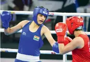  ?? — AFP ?? Sonia Chahal (in blue) lines up a punch against North Korea’s Son Hwa Jo during their 57kg semifinal at the Women’s World Boxing Championsh­ips on Friday.