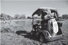  ?? THE ASSOCIATED PRESS ?? The golf cart and bag belonging to the late golfing great Arnold Palmer sits on a grassy spot next to the 16th tee as Patrick Rodgers hits from the rough alongside the 18th fairway during the first round of the Arnold Palmer Invitation­al in Orlando,...