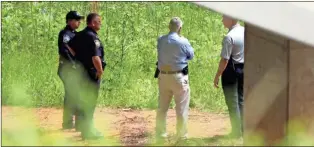  ?? Jeremy Stewart, File ?? In this May 13 file photo, Rome police and investigat­ors talk near the banks of the Etowah River under an East Rome bypass bridge where two bodies were found.