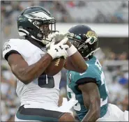  ?? PHELAN M. EBENHACK — THE ASSOCIATED PRESS ?? Philadelph­ia Eagles wide receiver Greg Ward, left, makes a reception in front of Jacksonvil­le Jaguars defensive back C.J. Reavis for a 38-yard touchdown play during the first half of an NFL preseason football game, Thursday in Jacksonvil­le, Fla.