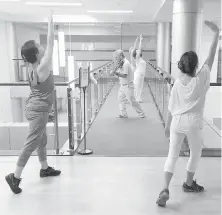  ??  ?? Violinist Anthony Hyatt leads dancers through MedStar Georgetown University Hospital.