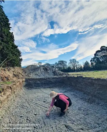  ??  ?? Candice examines the soil in her soon-to-be-built walipini.