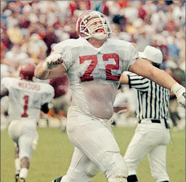  ?? Arkansas Democrat-Gazette file photo ?? Arkansas offensive lineman Verl Mitchell celebrates as wide receiver J.J. Meadors (background, left) heads toward the sideline after his sliding touchdown catch with six seconds remaining in the game helped the Razorbacks overcome a seven-point...