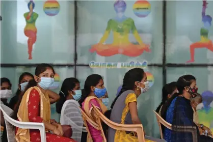  ?? Photograph: Arun Sankar/AFP/Getty Images ?? Indian frontline workers wait to get inoculated with the Covid-19 coronaviru­s vaccine at a government hospital in Chennai.