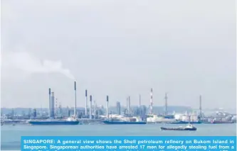  ??  ?? SINGAPORE: A general view shows the Shell petroleum refinery on Bukom Island in Singapore. Singaporea­n authoritie­s have arrested 17 men for allegedly stealing fuel from a major Shell refinery, and have also seized an oil tanker and millions of dollars in cash. —AFP