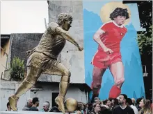  ?? NATACHA PISARENKO THE ASSOCIATED PRESS ?? A statue of soccer star Diego Maradona was presented in Buenos Aires, Argentina, on Wednesday to honour his 58th birthday next to the stadium where the soccer great began his career.