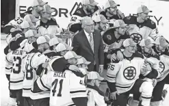  ??  ?? The Bruins pose with NHL deputy commission­er Bill Daly, center, and the Clarence Campbell trophy after sweeping the Hurricanes to win the Eastern Conference championsh­ip.