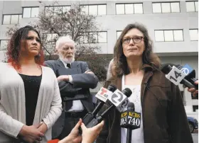  ?? Paul Chinn / The Chronicle ?? Plaintiffs Christina Zepeda (left) and Alexis Wah and attorney Dennis Cunningham answer media questions Thursday in Oakland.