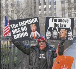  ?? AP photo ?? Protestors demonstrat­e outside Manhattan criminal court while awaiting the arrival of former President Donald Trump, Monday, in New York. A judge weighed on Monday that the former president will go on trial April 15.