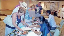  ??  ?? Sri Lanka Tourism Tourist Informatio­n Centre officials providing informatio­n for visitors on Aurora