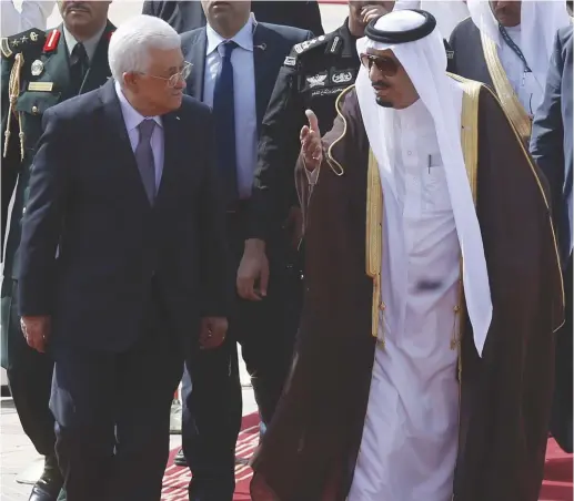  ?? (Faisal Al Nasser/Reuters) ?? SAUDI ARABIA’S King Salman bin Abdulaziz Al Saud walks with Palestinia­n President Mahmoud Abbas during a reception ceremony in Riyadh in 2015.