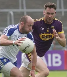  ??  ?? Daithí Waters pursuing Gavin Doogan of Monaghan.