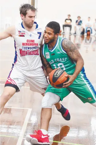  ?? Picture: RICHARD GOSLING ?? Rollers guard Deon Mitchell draws contact from a Toowoomba defender.