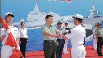  ?? LI GANG / XINHUA ?? President Xi Jinping, who is also general secretary of the Communist Party of China Central Committee and chairman of the Central Military Commission, presents the name certificat­e for the Changzheng 18, a nuclear-powered ballistic missile submarine, to its captain at a naval base in Sanya, Hainan province, on Sunday.