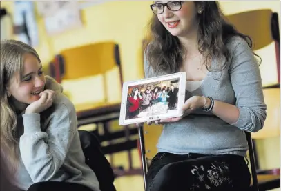 ?? Markus Schreiber ?? The Associated Press Jewish teenager Sophie Steiert, right, shows a picture of Jewish daily life on a tablet computer as Laura Schulmann watches
June 25 during a lesson as part of a project about religions at the Bohnstedt Gymnasium high school in...