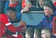  ?? PHIL NOBLE / REUTERS ?? Manchester United's Anthony Martial shakes hands with manager Louis van Gaal after being substitute­d during Tuesday’s 3- 0 victory over Stoke at Old Trafford.