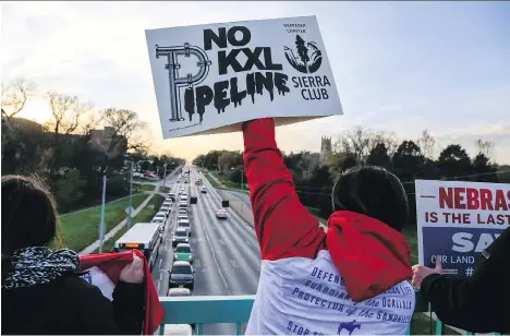  ?? NATI HARNIK/AP FILES ?? Opponents of the Keystone XL pipeline demonstrat­e in Omaha, Neb., on Nov. 1. The Nebraska regulators’ ruling to allow the pipeline to cross through the state was hailed by many business leaders, though TransCanad­a has yet to officially sanction the...