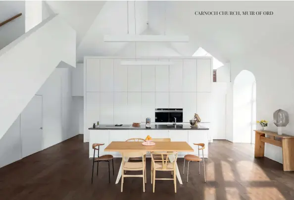  ??  ?? Above: The wall of kitchen units hides the second staircase. Bottom right: Contempora­ry interiors are flooded with natural light.