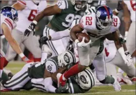  ?? JULIO CORTEZ — THE ASSOCIATED PRESS ?? New York Giants running back Wayne Gallman (22) is tackled by the New York Jets during the third quarter of a preseason NFL football game Friday.