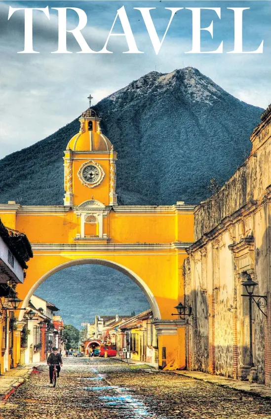  ?? Volcán de Agua(Volcano of Water) looms over the archway of Santa Catalina in Antigua,Guatemala. Dave Wilson WebArtz Photograph­y / Getty Images ??