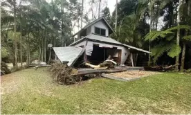  ?? ?? Flood waters rushed through the valley at Wilsons Creek on Monday, destroying most of the houses along the river. Photograph: Sahar Zadah