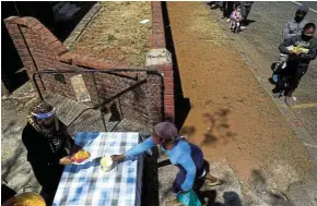  ?? Picture: Alon Skuy ?? Rising food costs will mean more South Africans go hungry. Here, grassroots charity Hunger has no Religion hands out food parcels in Johannesbu­rg during lockdown.