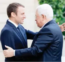  ??  ?? French President Emmanuel Macron welcomes Palestinia­n President Mahmoud Abbas at the Elysee Palace in Paris, France, Wednesday. (Reuters)