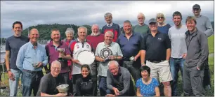  ??  ?? Sailors and prizewinne­rs from Oban Regatta with Commodore Finlo Cottier, far right, and race officer Colin Kupris, far left.