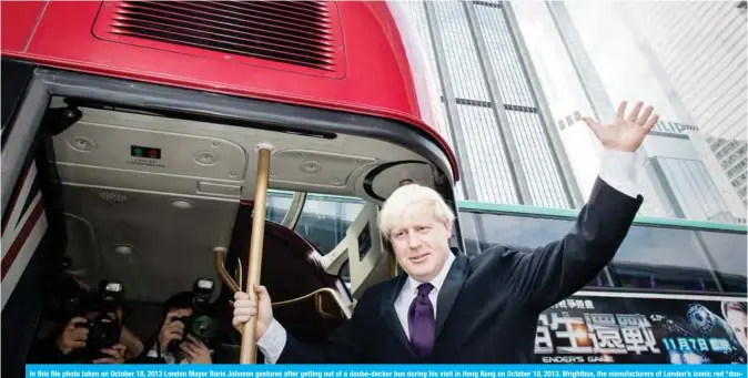  ??  ?? In this file photo taken on October 18, 2013 London Mayor Boris Johnson gestures after getting out of a doube-decker bus during his visit in Hong Kong on October 18, 2013. Wrightbus, the manufactur­ers of London’s iconic red “double decker” buses, entered administra­tion yesterday, a spokesman for the company confirmed. —AFP