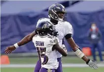  ?? Andy Lyons / Getty Images ?? The Ravens’ Lamar Jackson and Marquise Brown celebrate a 20-13 wild-card win over the Titans. In other action Sunday, the Saints beat the Bears 21-9, and the Browns upset the Steelers 48-37.