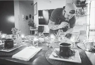  ?? DARRYL DYCK THE CANADIAN PRESS ?? Chef Travis Petersen uses a dropper to add THC distillate to an amuse bouche of toasted farro and young pine broth before guests arrive for a multi-course cannabis-infused meal in Vancouver.