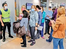  ?? —
AFP ?? Staff volunteers queue to receive a fourth dose of the Pfizer-BioNTech Covid-19 vaccine at the Sheba Medical Centre in Ramat Gan, Israel, on Monday.