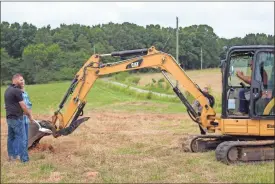  ?? kevin Myrick ?? An excavator was pulled out to help clear some dirt to move the first shovelful at the forthcomin­g home of the IUOE’s Local 926 training center in Polk County.