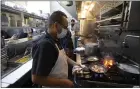  ??  ?? Jaime Hernandez cooks shrimp at Brenda’s French Soul Food in San Francisco.
